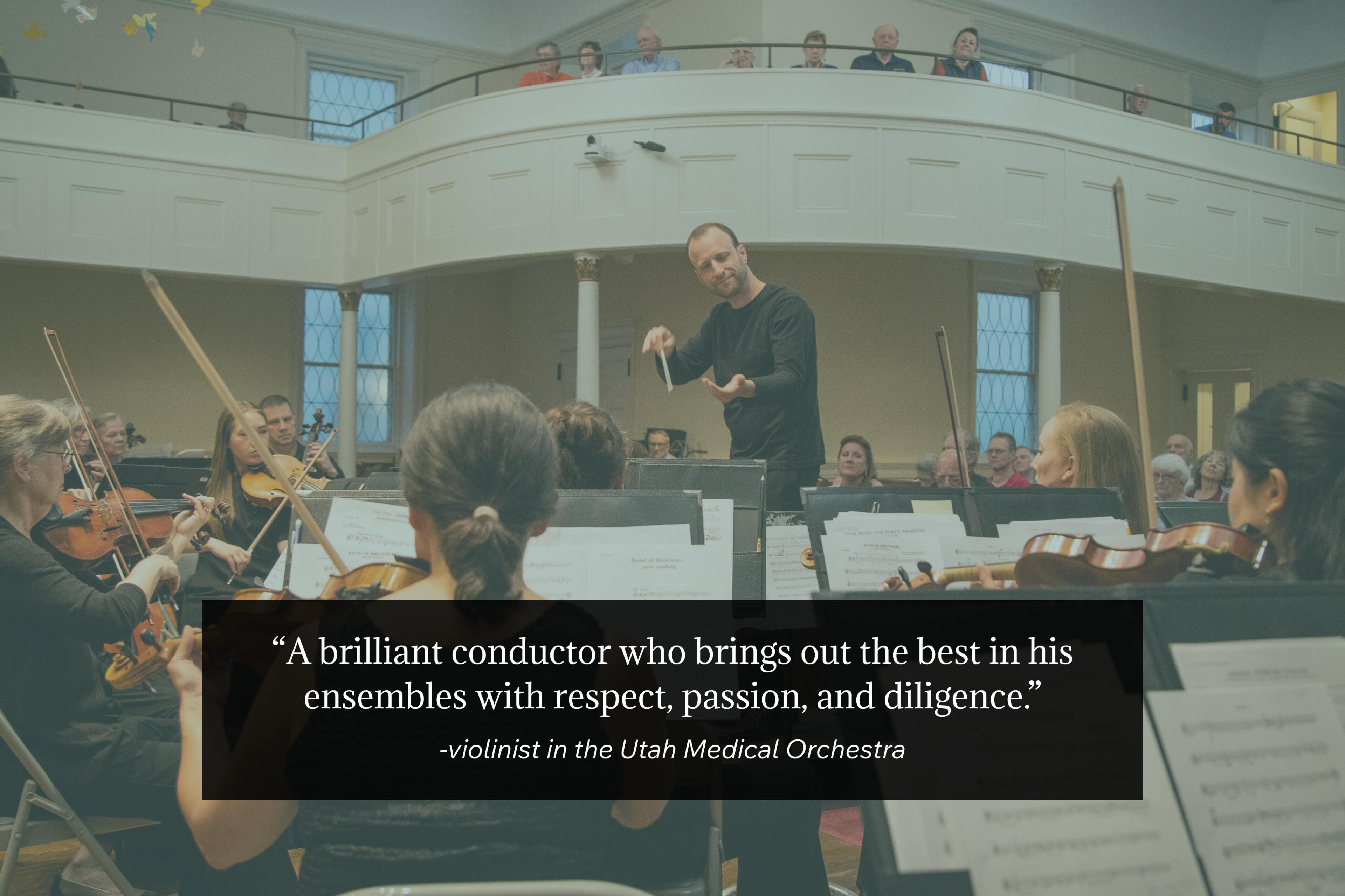 Photo by Wendy Redfern Dr. Matthew Mainella stands on a podium in front of an orchestra. His eyes are half-closed and he is smiling as his hands gesture to bring the violins in. A quote by one of his orchestra members is in the foreground.